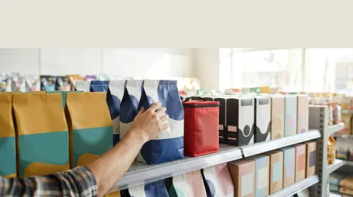 A hand reaches for a deep-blue kibble bag on a colour-blocked pet-food shelf, color psychology in branding on the aisle